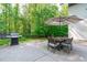 Outdoor dining and grill on this home's large and modern patio at 9021 Albatross Ct, Raleigh, NC 27613