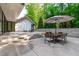 Great patio with dining area and fireplace with steps up to the backyard at 9021 Albatross Ct, Raleigh, NC 27613