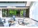 Spacious patio featuring a fire pit and modern seating next to folding glass doors at 9021 Albatross Ct, Raleigh, NC 27613