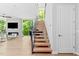 Bright interior showcases floating wood staircase, sleek metal railing, and elegant design at 9021 Albatross Ct, Raleigh, NC 27613
