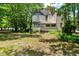 Expansive backyard featuring mature trees, creating a serene and natural environment at 903 Nicholas St, Henderson, NC 27536