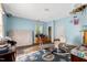 Light-filled bedroom with blue walls, a window, and original architectural details at 903 Nicholas St, Henderson, NC 27536