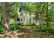 Quaint home nestled amongst lush trees and foliage, offering a tranquil setting at 903 Nicholas St, Henderson, NC 27536