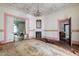 Large living room with fireplace, pink accents and vintage chandelier at 903 Nicholas St, Henderson, NC 27536
