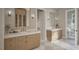 Dual sink bathroom featuring wood cabinetry, marble countertops, and modern lighting fixtures at 913 Tyrrell Rd, Raleigh, NC 27609
