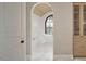 Elegant bathroom with an arched window, standalone tub, and marble patterned walls at 913 Tyrrell Rd, Raleigh, NC 27609