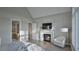 A calming bedroom features a fireplace, white trim and vaulted ceilings at 913 Tyrrell Rd, Raleigh, NC 27609