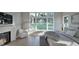 Bedroom featuring fireplace, bench seating, and a large window for backyard views at 913 Tyrrell Rd, Raleigh, NC 27609