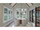 Dining room filled with natural light offers views to the outdoor area and a modern chandelier at 913 Tyrrell Rd, Raleigh, NC 27609