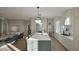 Open-concept kitchen and living room with large island, modern appliances, and ample cabinet space at 913 Tyrrell Rd, Raleigh, NC 27609