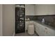 Well-organized laundry room featuring a stacked washer and dryer unit and ample cabinet space at 913 Tyrrell Rd, Raleigh, NC 27609