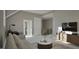 Neutral toned living room with seating area, TV, and view of the stairs at 913 Tyrrell Rd, Raleigh, NC 27609
