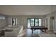 Spacious living room featuring a pool table, hardwood floors, and sliding doors to the outside at 913 Tyrrell Rd, Raleigh, NC 27609