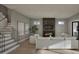 Inviting living room showcasing a fireplace, stairs, hardwood flooring, and comfortable white couches at 913 Tyrrell Rd, Raleigh, NC 27609