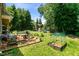 Backyard showing patio with furniture, gardening area, and wooden play structure at 10205 Sorrills Creek Ln, Raleigh, NC 27614