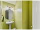 Small bathroom with a pedestal sink and bright lighting at 10205 Sorrills Creek Ln, Raleigh, NC 27614