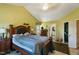 Bedroom with high ceiling, wood furniture, with an ensuite bathroom and walk-in closet at 10205 Sorrills Creek Ln, Raleigh, NC 27614