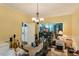 Dining area with yellow walls, chandelier, and exercise equipment at 10205 Sorrills Creek Ln, Raleigh, NC 27614