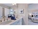 Bathroom featuring double sinks and a mirror, with view to bedroom at 1021 Dillon Lake Dr, Knightdale, NC 27545