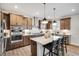 Stylish kitchen featuring an island with seating, pendant lighting, and stainless steel appliances at 1021 Dillon Lake Dr, Knightdale, NC 27545