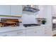 This kitchen features a stainless steel range hood and bright white cabinets at 1021 Dillon Lake Dr, Knightdale, NC 27545