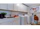 Laundry room featuring ample storage, white cabinets and laundry machines at 1021 Dillon Lake Dr, Knightdale, NC 27545