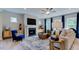 Living room with fireplace, blue accent chair, and ample natural light at 1021 Dillon Lake Dr, Knightdale, NC 27545