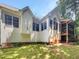 Backyard view of a two-story home with many windows and a screened in porch at 105 Crosswaite Way, Cary, NC 27518