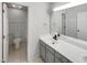 Bathroom with double sink vanity with gray cabinets, toilet room, and large mirror at 105 Crosswaite Way, Cary, NC 27518