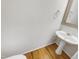 Bathroom featuring pedestal sink, mirror, and wood floors at 105 Crosswaite Way, Cary, NC 27518