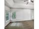 Spacious bedroom featuring carpet floors, neutral walls, and a tray ceiling with a ceiling fan at 105 Crosswaite Way, Cary, NC 27518