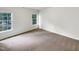 An empty bedroom showing neutral carpet, two windows, and blank white walls at 105 Crosswaite Way, Cary, NC 27518