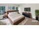 Beautiful bedroom with a large bed, white bedding, two windows, and dark furniture at 105 Crosswaite Way, Cary, NC 27518