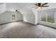 Bonus room featuring carpet floors, neutral walls, and a vaulted ceiling with two ceiling fans at 105 Crosswaite Way, Cary, NC 27518