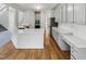 Spacious kitchen with white countertops, gray cabinets, stainless steel appliances, and hardwood floors at 105 Crosswaite Way, Cary, NC 27518
