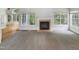 Spacious living room with carpet, a fireplace, large windows, and access to other rooms at 105 Crosswaite Way, Cary, NC 27518