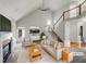 Bright, open living room with fireplace, vaulted ceilings, and view of the staircase at 105 Crosswaite Way, Cary, NC 27518