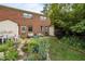 Charming backyard with brick patio, colorful plants, and a cozy seating area at 105 Fidelity St # B19, Carrboro, NC 27510