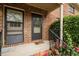 Close up view of the brick entryway, with a black railing, and blooming flowers at 105 Fidelity St # B19, Carrboro, NC 27510