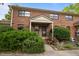 Traditional brick townhouse with landscaped yard and covered entryway with nice shrubbery and flowers at 105 Fidelity St # B19, Carrboro, NC 27510