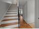 Bright foyer featuring hardwood floors, a staircase with white risers and a black railing at 105 Fidelity St # B19, Carrboro, NC 27510