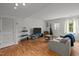 Spacious living room features hardwood floors, a tv, and a sliding door to the backyard at 105 Fidelity St # B19, Carrboro, NC 27510