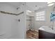 Bathroom with white subway tile shower, decorative accent, and wood-look flooring at 1195 Champion Dr, Cary, NC 27511