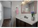 Cozy bathroom featuring stylish vanity, granite countertop, and a framed mirror above sink at 1195 Champion Dr, Cary, NC 27511