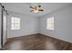 Bright bedroom features wood-look floors, two windows, and neutral walls at 1195 Champion Dr, Cary, NC 27511