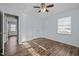 Bedroom featuring wood-look floors, a large window, and neutral walls at 1195 Champion Dr, Cary, NC 27511