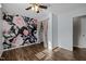 Bedroom featuring wood-look floors, a wallpapered accent wall, and walk-in closet at 1195 Champion Dr, Cary, NC 27511