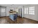 Bright kitchen features white cabinets, stainless steel appliances, a granite island, and stylish pendant lighting at 1195 Champion Dr, Cary, NC 27511