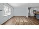 Bright living space with hardwood floors, large windows, and seamless flow into the modern kitchen area at 1195 Champion Dr, Cary, NC 27511