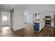 Open living area with wood floors, leading to a stylish kitchen with stainless appliances at 1195 Champion Dr, Cary, NC 27511